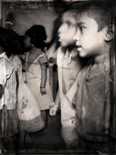 Children sing at a free school in a slum just north of Mumbai, India